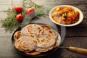 Indian vegan food recipes- wheat paratha  served with curry