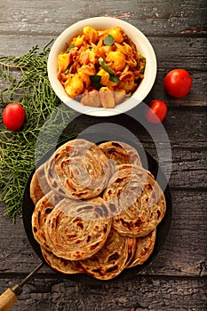 Indian vegan foods- Top view wheat paratha with dum aloo.