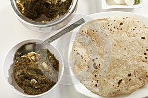 Indian vegetable food Spinach with cottage cheese with raw vegetables with chapati.