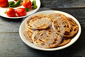 Indian vegetarian cuisine- - wheat paratha with dum aloo.