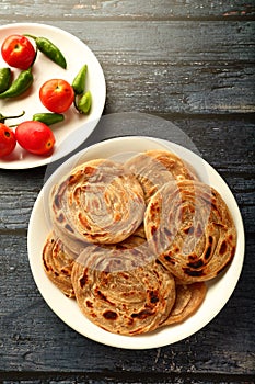 Indian vegetarian cuisine- - wheat paratha with dum aloo.