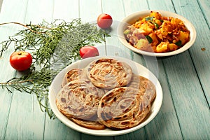 Indian vegetarian cuisine- - wheat paratha with dum aloo.