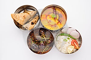 Indian Veg Lunchbox for office of workplace with Baingan Masala, dal fry rice and chapati photo