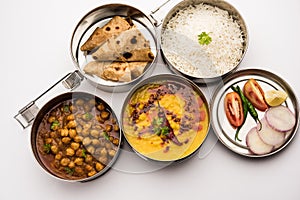 Indian Veg Lunchbox for office of workplace with chole, dal fry rice and chapati photo