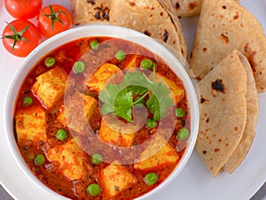 Indian matar paneer curry served with roti photo