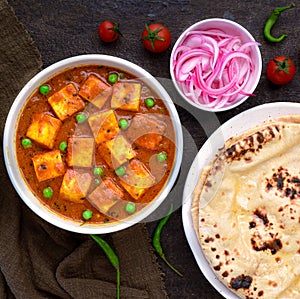 Indian vegetarian meal - matar paneer and roti with pickled onions photo