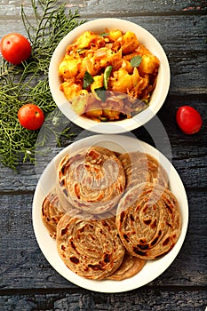 Indian vegetarian recipes- - wheat paratha with dum aloo.