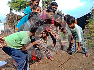 indian village childrens plying Gilli danda game together at village area in India January 1, 2020