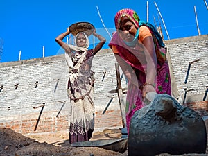 indian village female labour holded spade handle on construction site in India January 2020