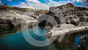 Indian village fisherman, blue water blue sky, photography,brown stones
