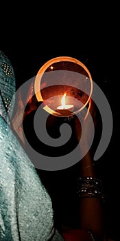 An indian village lady Worshipping in karwa chowth at night