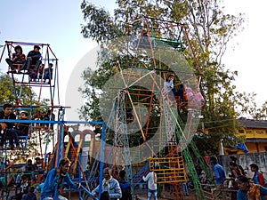 indian village people enjoying swing at local fair program in India January 2020