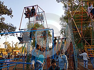 indian village people enjoying swing at local fair program in India January 2020