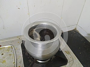 Indian villages redtea in home creat at gas stove photo