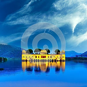 Indian water palace on Jal Mahal lake at night time in Jaipur