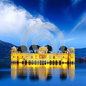 Indian water palace on Jal Mahal lake at night time in Jaipur photo