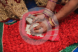 Indian wedding ceremony : bangle in bridal hand with mehandi design