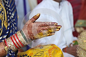 Indian wedding ceremony : bangle in bridal hand with mehandi design