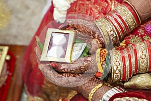 Indian wedding ceremony : bangle in bridal hand with mehandi design