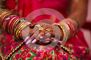 Indian wedding ceremony : bangle in bridal hand with mehandi design