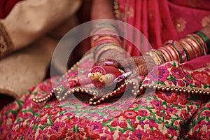 Indian wedding ceremony : bangle in bridal hand with mehandi design