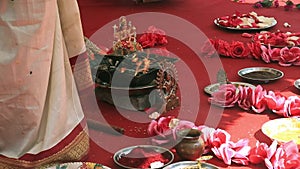 Indian wedding ceremony, decorations for traditional ethnic rituals for marriage, fire burning, flowers and statuettes of the deit