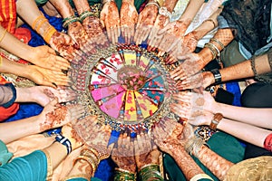 Indian wedding mehndi hands shown by girls and bride in circle