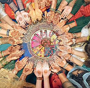 Indian wedding mehndi hands shown by girls and bride in circle
