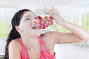 Indian woman with bunch of grapes