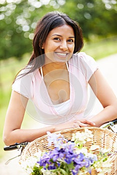 Indian Woman On Cycle Ride In Countryside