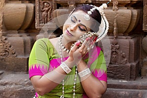 Indian woman dancing in classic suit Odissi. Classical dancer holding Ghungroo