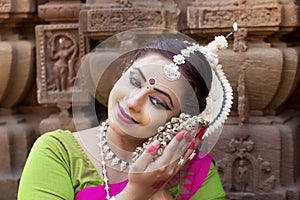 Indian woman dancing in classic suit Odissi. Close up View of Classical dancer holding Ghungroo
