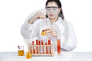 Indian woman doing research with liquid