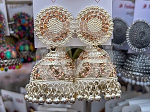 Indian woman ear ring jewellery displayed in street shop