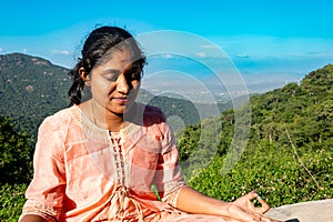 An Indian Woman Embraces Serenity in Mountain Meditation