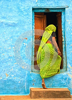 Indian woman entering the door