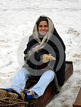Women enjoy small sledge on snow photo