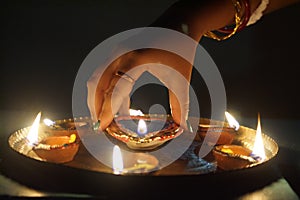 Indian Woman Lighting Oil Lamps