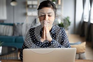 Indian woman pray make wish sit at home with laptop