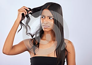 Indian woman, problem or bad hair care in studio for unhealthy damage, trouble or frizzy texture. Sad, upset or