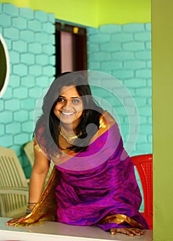 Indian Woman in Purple Saree Bending and Standing