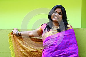 Indian Woman in Purple Saree standing and smiling