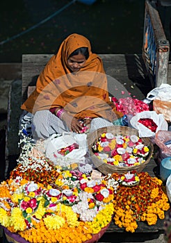 Indian woman selling pooja items in Varanasi, India