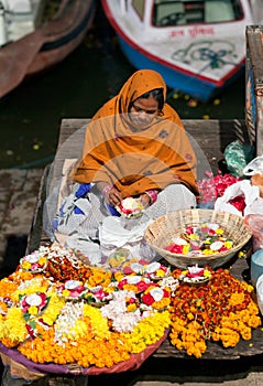 Indian woman selling pooja items in Varanasi, India