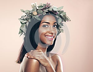 Indian woman, smile and portrait with flower wreath or beauty on plant background, sustainability or eco friendly
