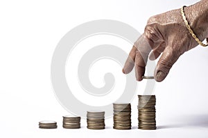 Indian woman stacking coins on white background. Business concept
