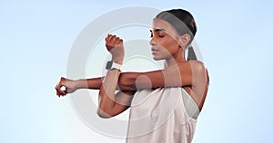 Indian woman, stretching arms and athlete in studio with fitness, workout and muscle on blue background. Warm up