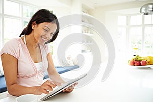 Indian Woman Using Digital Tablet At Home