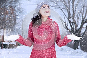 Indian woman with warm clothes playing snow