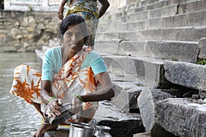 Indian woman washing dishes